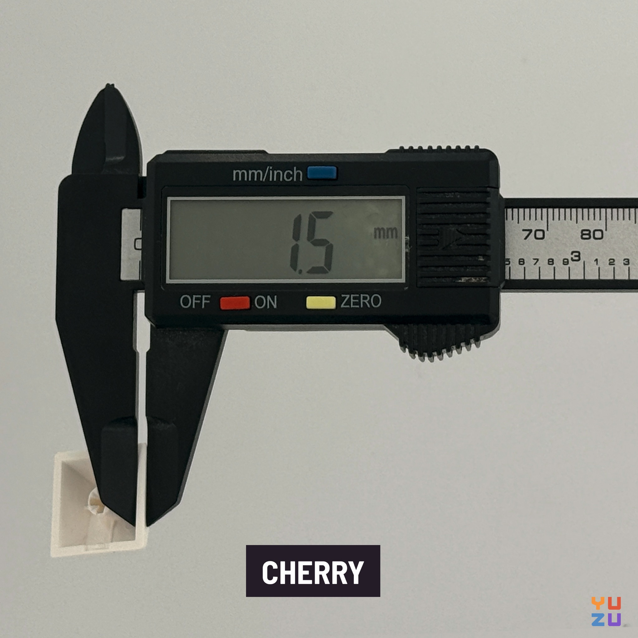 Caliper measuring the wall thickness of Cherry keycaps